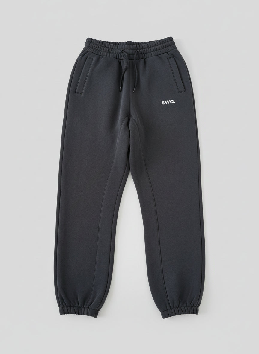 Black sweatpants with 'swa.' logo on a light gray background