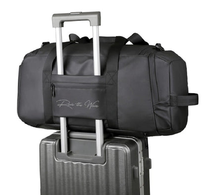 Black duffel bag with a handle on top of a suitcase on a white background