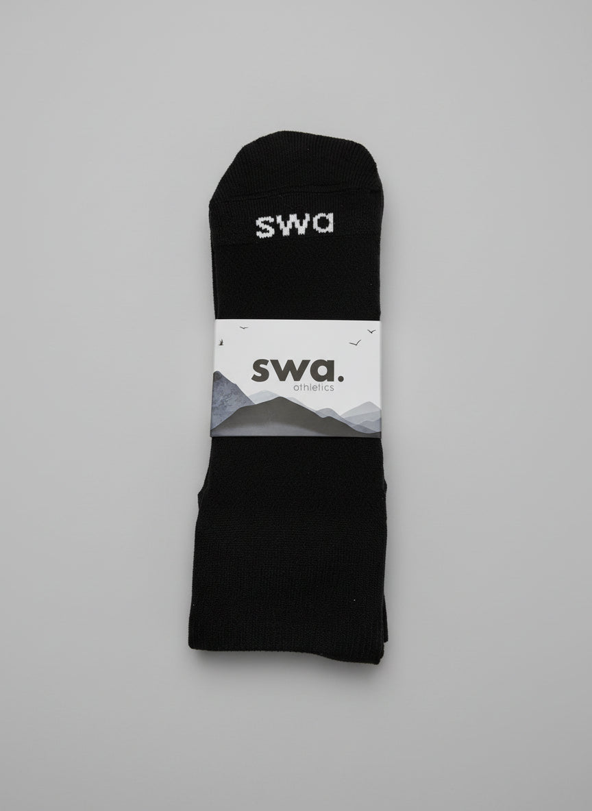 Black swa socks with a white label on a gray background