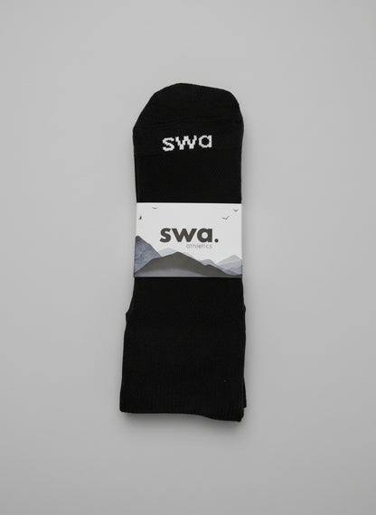 Black swa socks with a white label on a gray background